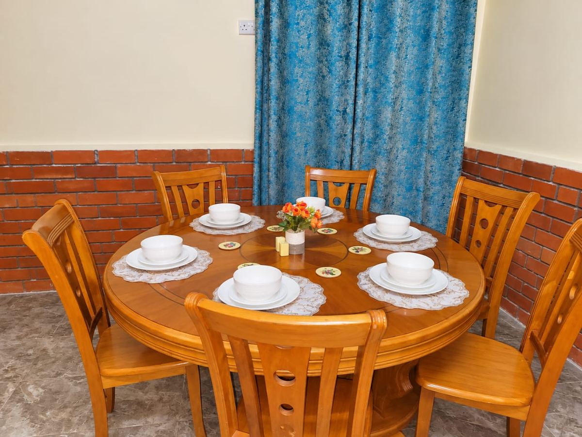 Round dining table laid for six in the restaurant
