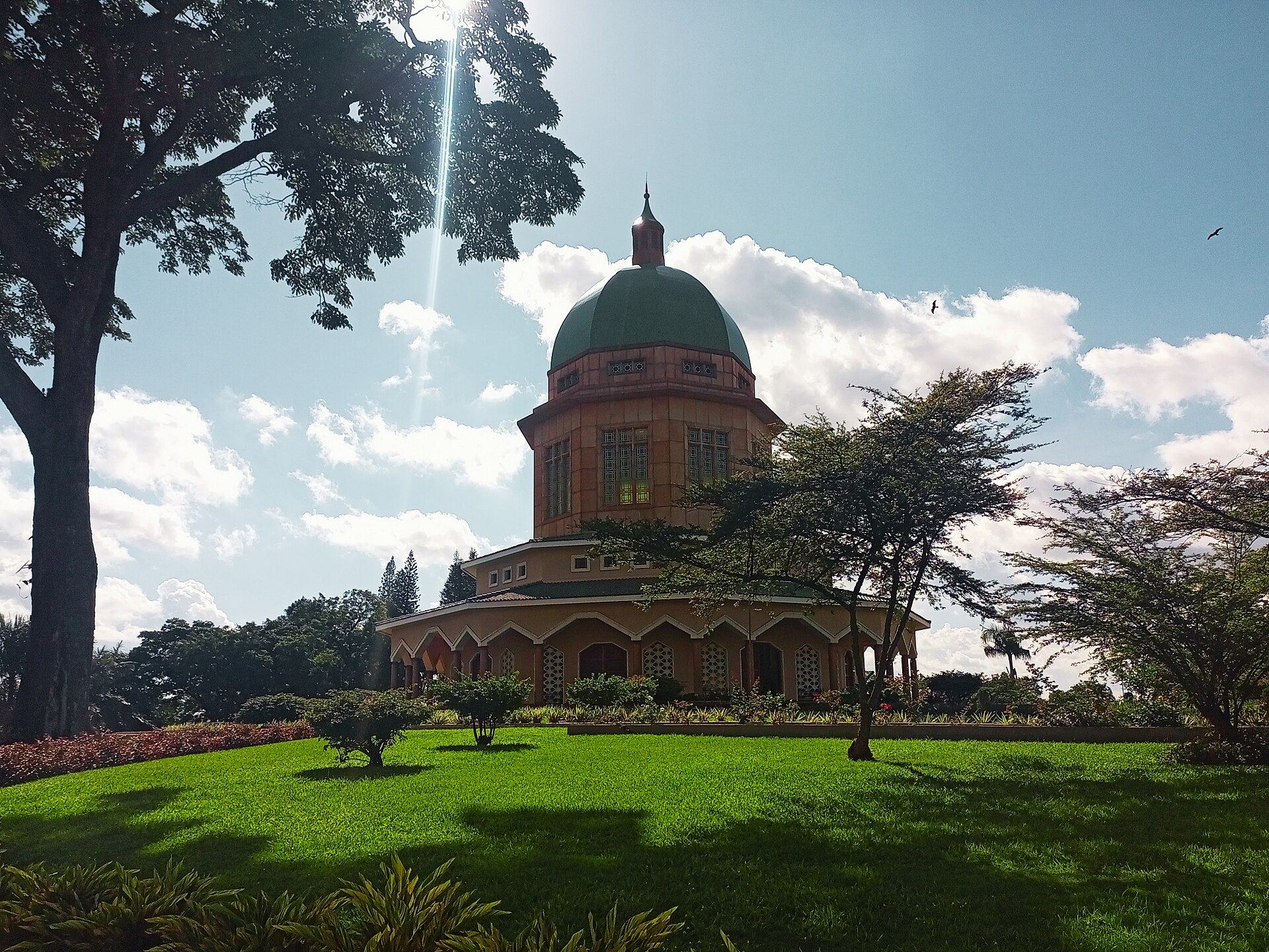 The green dome of the Bahá’í House of Worship on Kikaaya Hill, above its gardens
